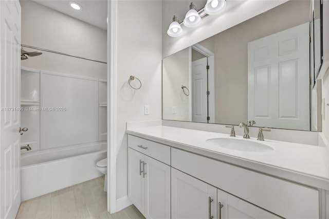 full bathroom featuring vanity, washtub / shower combination, and toilet