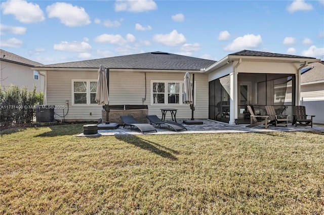 back of house featuring cooling unit, a lawn, a sunroom, and a patio