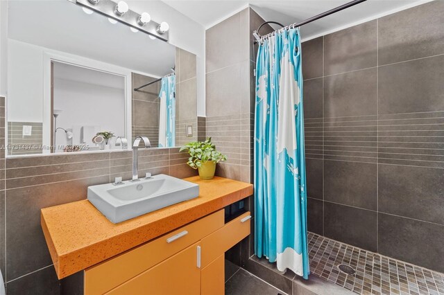 bathroom with vanity, tile patterned flooring, a shower with shower curtain, and tile walls