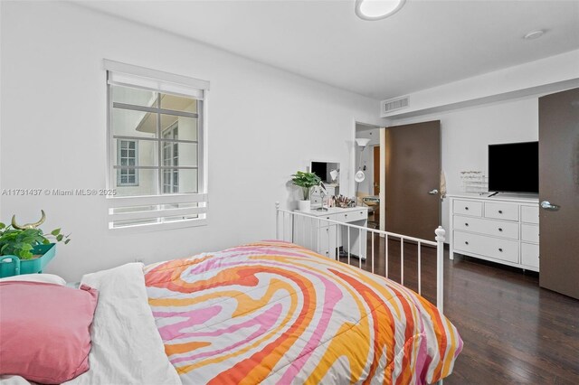 bedroom with dark wood-type flooring