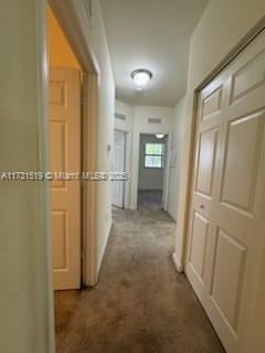 hallway featuring carpet flooring