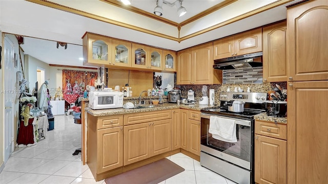 kitchen with light tile patterned flooring, sink, light stone counters, stainless steel range with electric stovetop, and ornamental molding