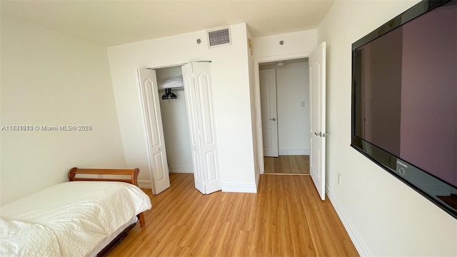 bedroom featuring a closet and light hardwood / wood-style flooring