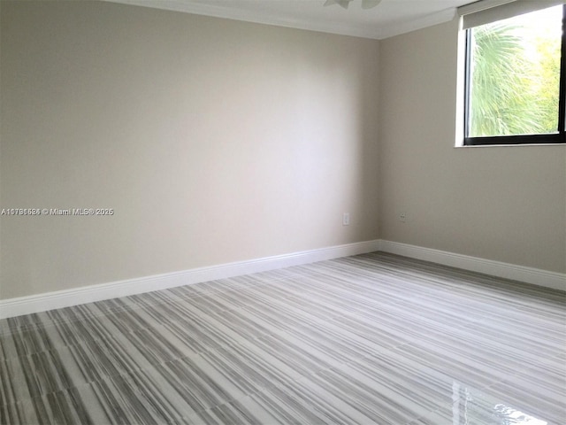 unfurnished room featuring crown molding