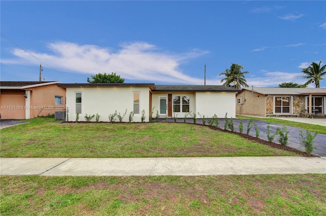 single story home featuring central AC and a front yard