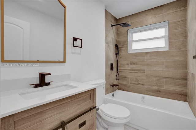 full bathroom with tiled shower / bath combo, vanity, and toilet