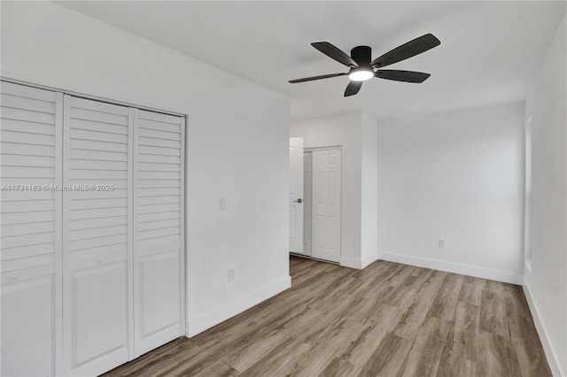 unfurnished bedroom with light hardwood / wood-style flooring and ceiling fan