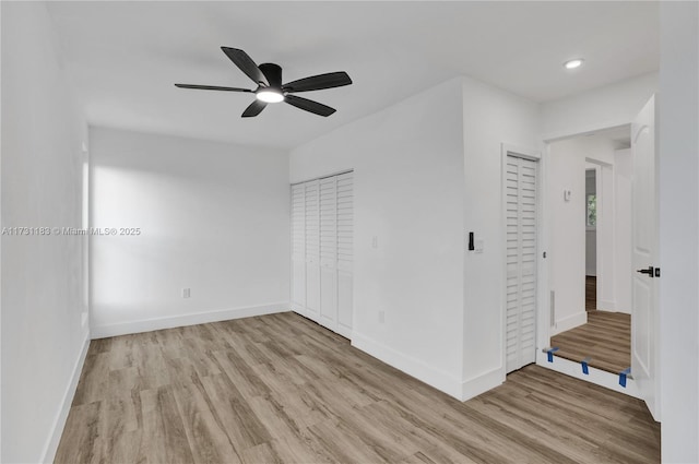 empty room featuring ceiling fan and light hardwood / wood-style flooring