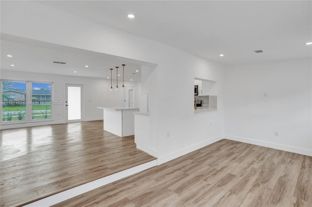 unfurnished living room with light hardwood / wood-style floors