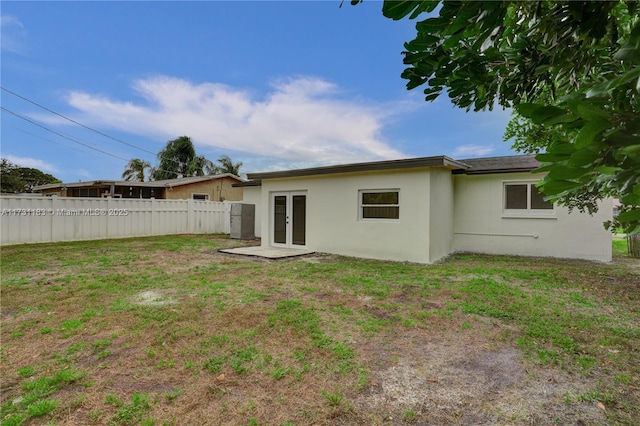 rear view of house with a yard