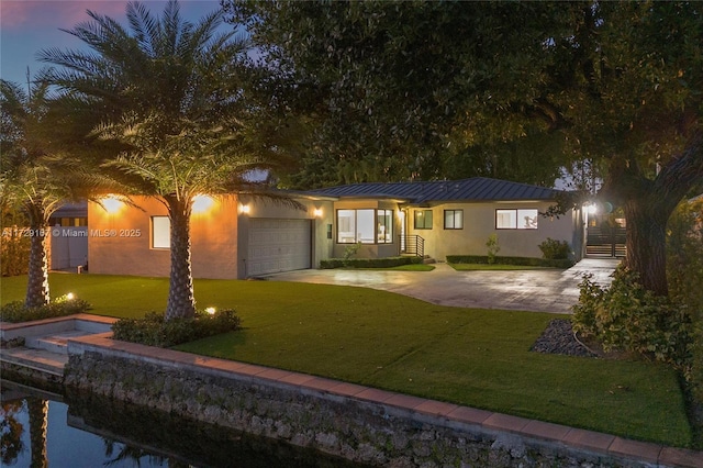 view of front of house featuring a water view and a front lawn