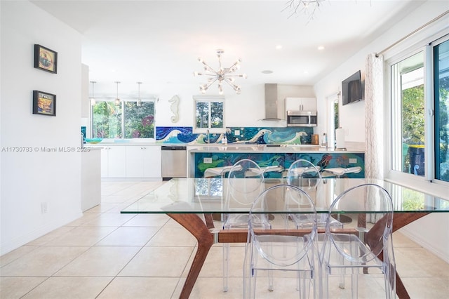 tiled dining area featuring an inviting chandelier