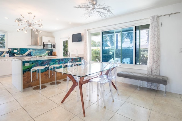 tiled dining room featuring a notable chandelier