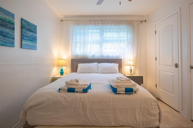 tiled bedroom featuring ceiling fan