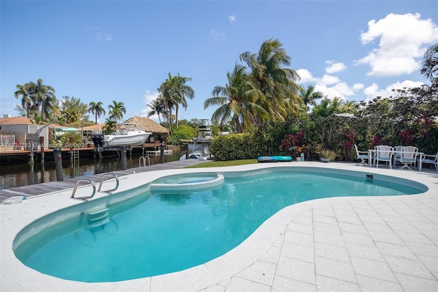 view of pool featuring a water view, a boat dock, and a patio area