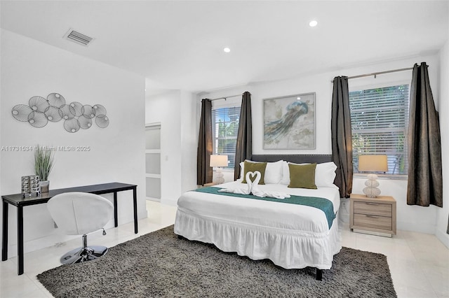 tiled bedroom featuring multiple windows