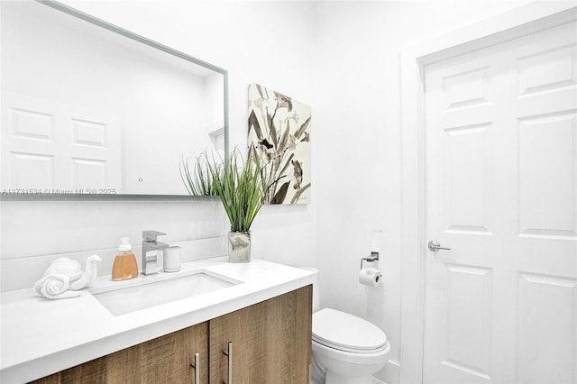 bathroom featuring vanity and toilet