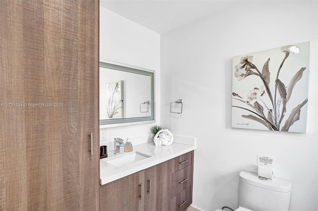 bathroom featuring vanity and toilet