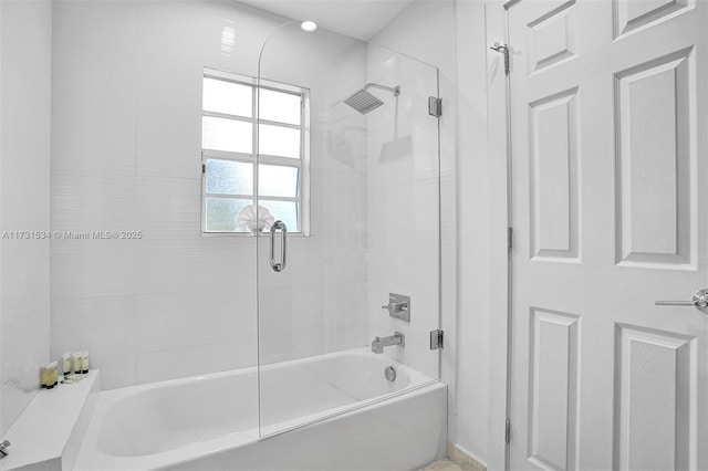 bathroom with shower / bath combination with glass door