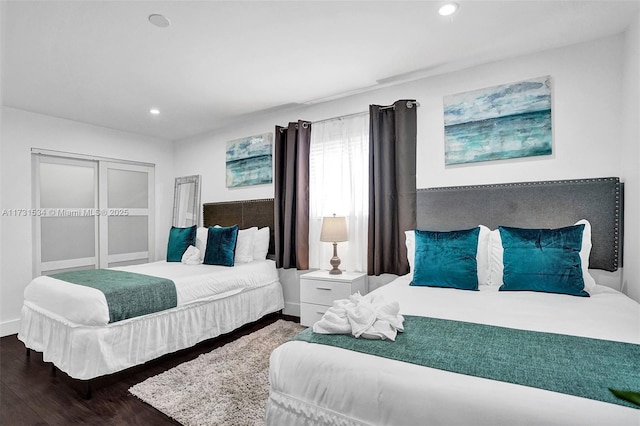 bedroom with dark wood-type flooring