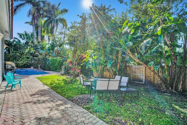 view of yard with a fenced in pool and a patio