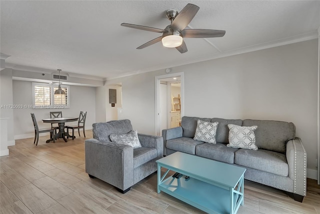 living room featuring ornamental molding and ceiling fan