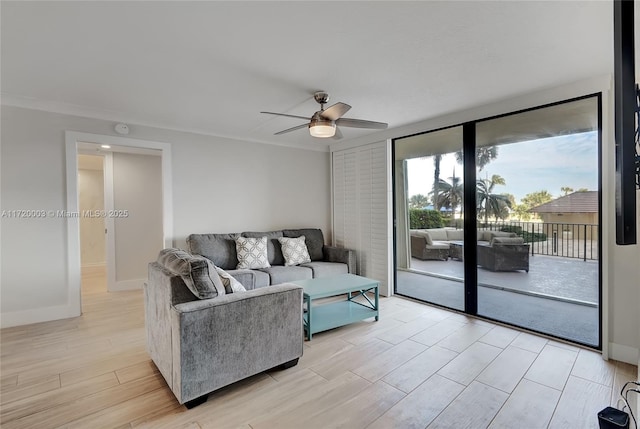 living room featuring ornamental molding and ceiling fan