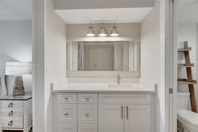 bathroom featuring vanity and toilet