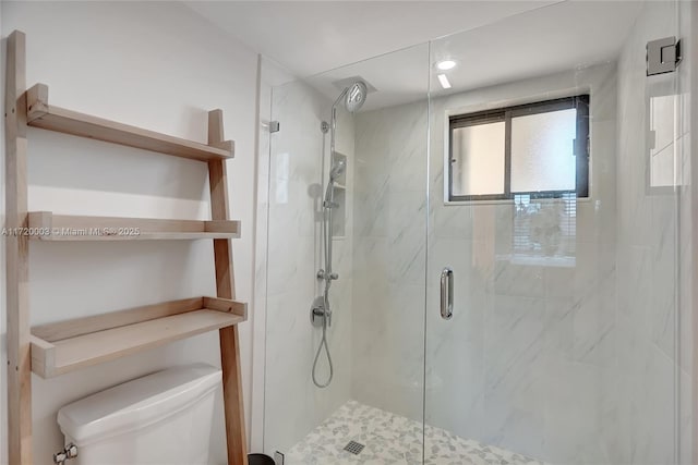 bathroom featuring an enclosed shower and toilet