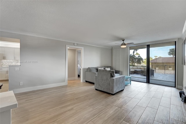 living room featuring ornamental molding, ceiling fan, and light hardwood / wood-style floors