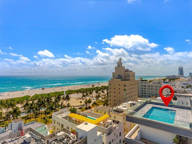 aerial view with a water view and a view of the beach