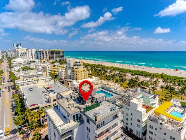 birds eye view of property with a water view and a view of the beach