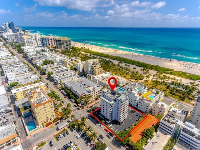 drone / aerial view with a water view and a view of the beach