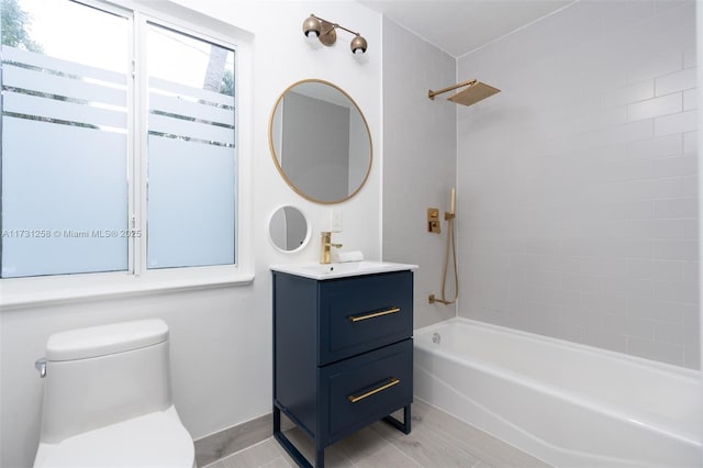 full bathroom featuring vanity, toilet, and tiled shower / bath combo