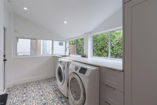 clothes washing area featuring separate washer and dryer, sink, and plenty of natural light