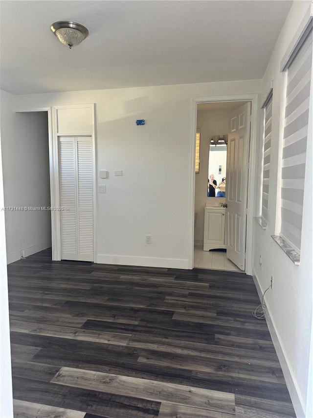 empty room with dark wood-type flooring