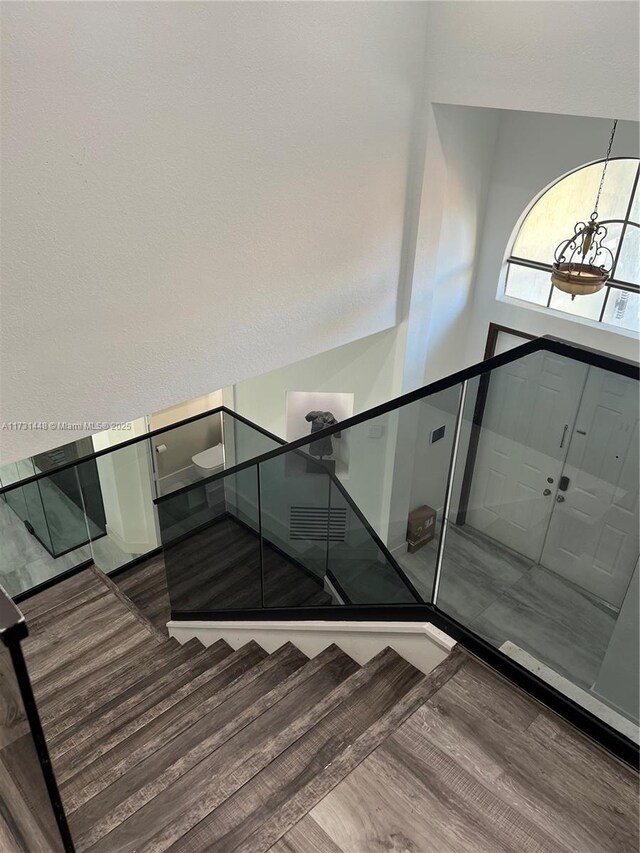 staircase with wood-type flooring