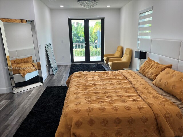 bedroom featuring wood-type flooring, access to outside, and french doors