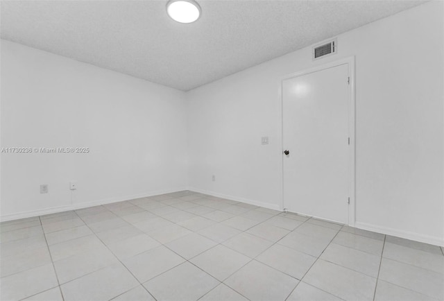 unfurnished room featuring a textured ceiling