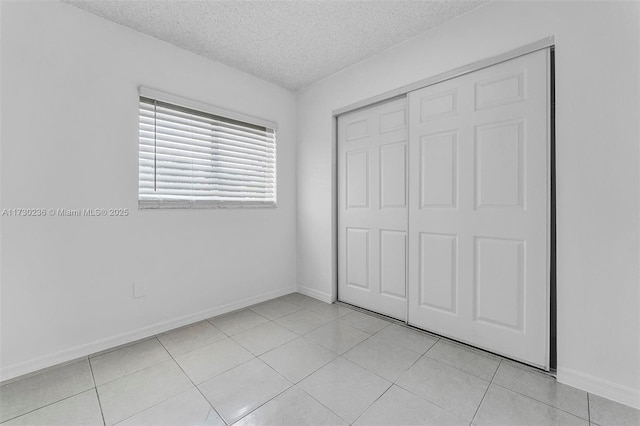 unfurnished bedroom featuring a closet and a textured ceiling