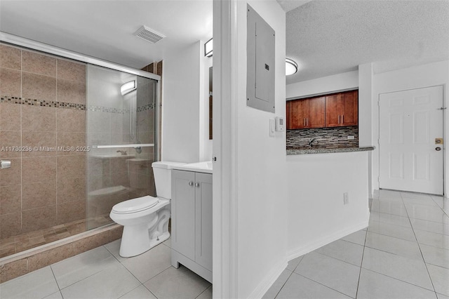 bathroom with decorative backsplash, vanity, walk in shower, toilet, and tile patterned floors