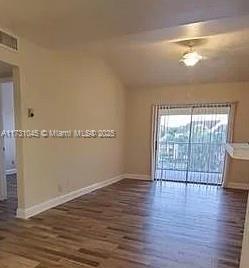 spare room with dark wood-type flooring