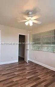 unfurnished bedroom with dark hardwood / wood-style flooring and ceiling fan