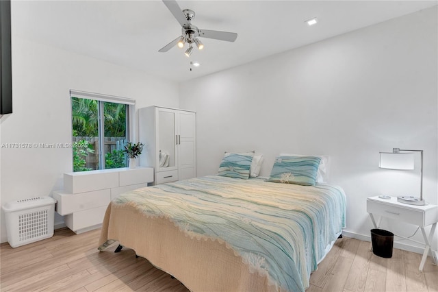 bedroom with ceiling fan and light hardwood / wood-style floors