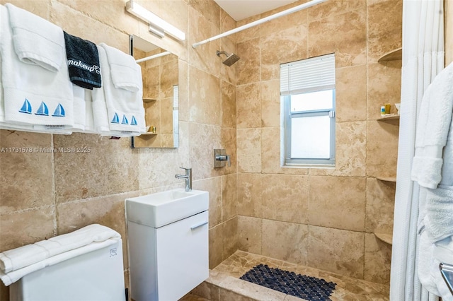 bathroom featuring vanity and tiled shower