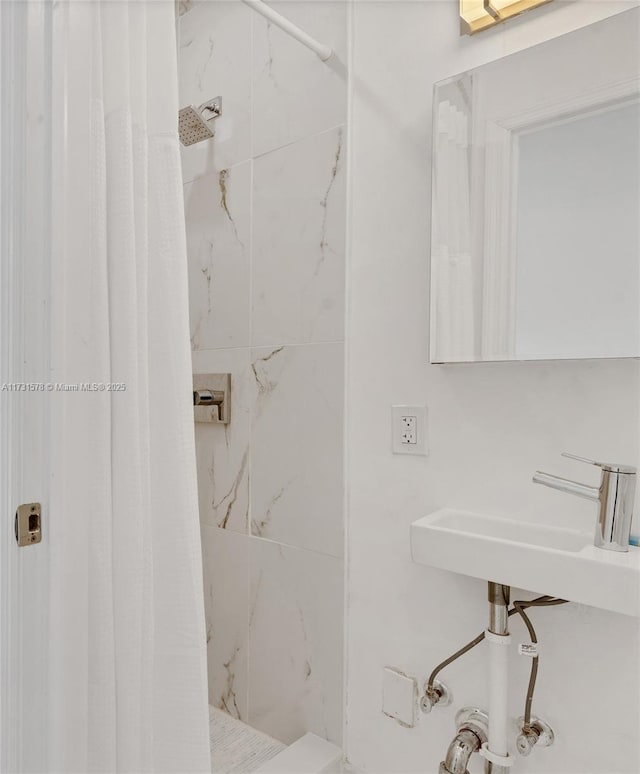 bathroom with sink and curtained shower