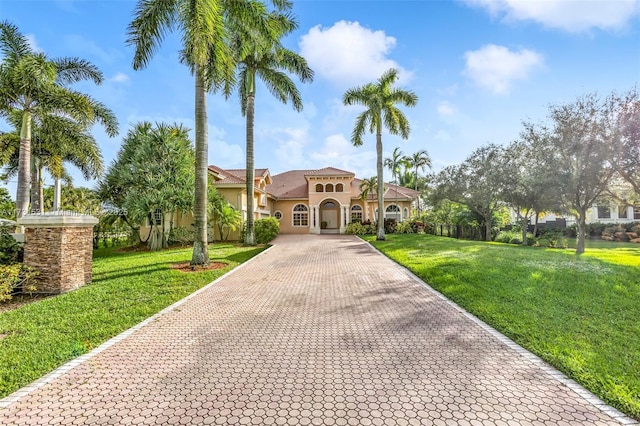 mediterranean / spanish home featuring a front lawn