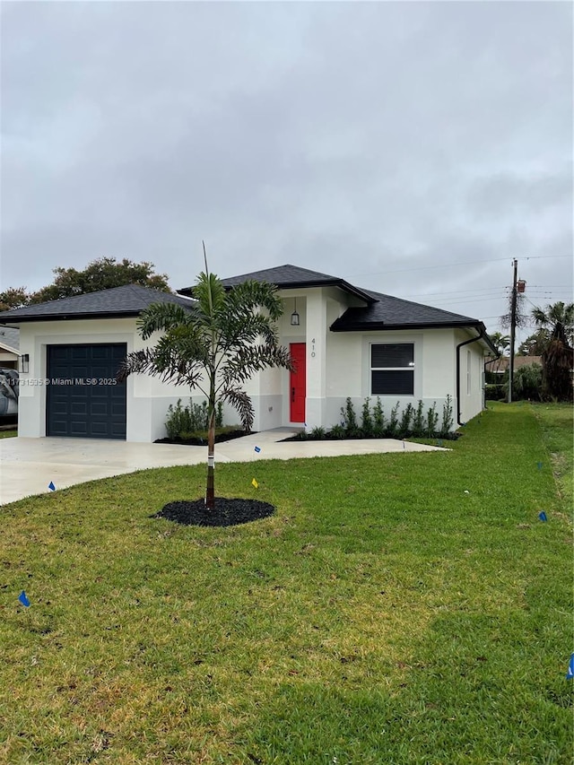 view of front of house with a garage and a front lawn