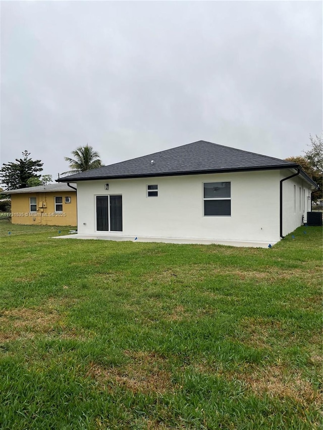 back of property featuring a yard, central AC unit, and a patio area