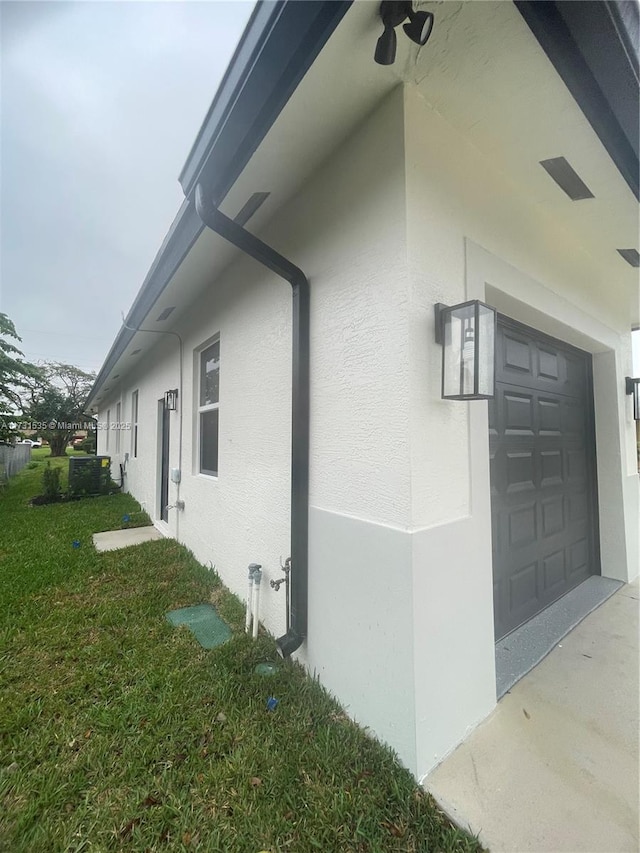 view of side of home with a garage and a yard